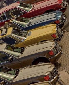 a row of old cars parked next to each other