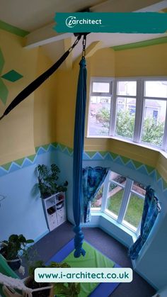 an aerial view of a bedroom with a hammock hanging from the ceiling and windows