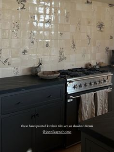 a stove top oven sitting inside of a kitchen next to a wall covered in tiles