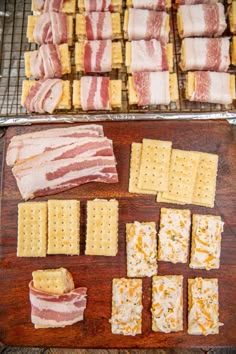 bacon, cheese and crackers laid out on a cutting board next to each other