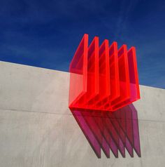 an instagram page with the image of a red sculpture on it's left side