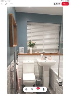 a white toilet sitting next to a sink in a bathroom