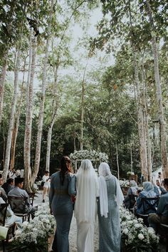 two brides are walking down the aisle together