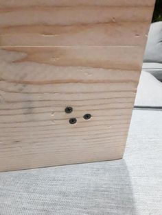 a piece of wood that has some screws in it