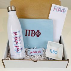 a gift box with personal items in it, including a water bottle and coasters