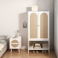 a white cabinet sitting next to a bed on top of a hard wood floored floor