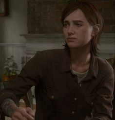 the last of us part 2 - screenshote, with an image of a person sitting at a table