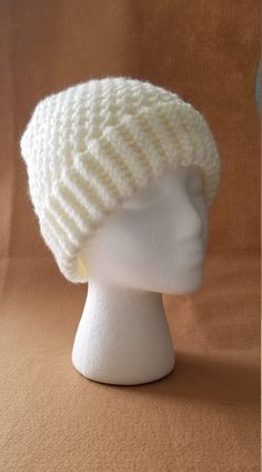 a white knitted hat on a mannequin head