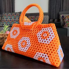 Beautiful Handmade Orange And White Beaded Handbag. This Unique Handbag Will Be A Great Addition To You Out. Length: 14.5 Inches Height: 7 Inches Depth: 5 Inches Strap: 5 Inches Inside: Orange Cloth On The Inside Beaded Crochet Rectangular Bag For Beach, Summer Beaded Crochet Bag For Daily Use, Rectangular Beaded Crochet Bag For Daily Use, White Beaded Bags For Summer, White Beaded Summer Bags, Daily Use White Beaded Bags, Summer White Beaded Bags, Square Beaded Shoulder Bag For Beach, White Beaded Bag For Everyday Use