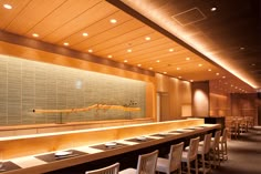 an empty restaurant with long tables and chairs