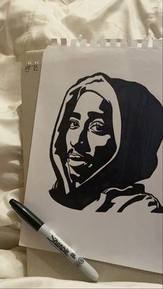 a black and white drawing of a woman's face on a piece of paper