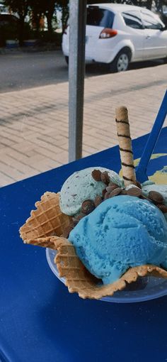 an ice cream sundae on a blue table