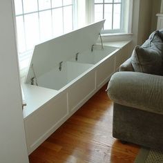 a living room filled with furniture next to a window