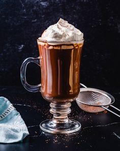 a cup of hot chocolate with whipped cream on top