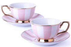 two cups and saucers with gold rims on white background, one is pink and the other is striped