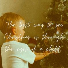 a little boy looking at a christmas tree with the words, the best way to see christmas is through the eyes of a child