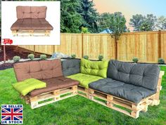 a couch made out of wooden pallets with cushions on the back and green cushions