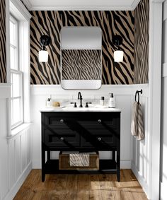 a zebra print wallpaper in a bathroom with two sinks and a mirror on the wall