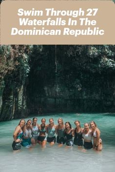 a group of women standing in the water with text overlay reading swim through 27 waterfalls in