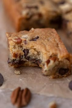 chocolate chip cookie bars with pecans scattered around them