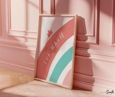 an empty frame on the floor in front of a wall with pink walls and wood floors