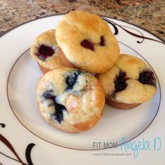 three blueberry muffins on a white plate