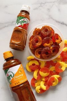 there are many different types of food on the counter top next to some bottles and sauces