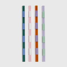 three different colored pencils sitting next to each other