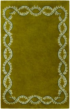 a green rug with an ornate border in the middle and white trim around the edges