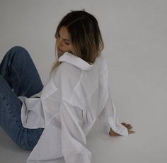 a woman sitting on the floor with her legs crossed