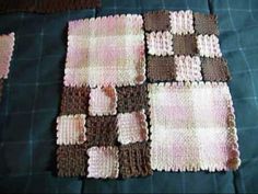 crocheted squares laid out on a bed