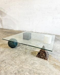 a glass table sitting on top of a cement floor