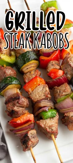 grilled steak kabobs on a white plate