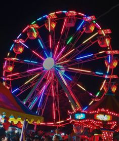 a ferris wheel lit up at night time