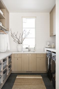 a clean and organized laundry room with washer and dryer