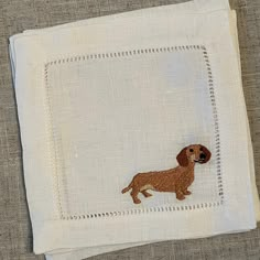 a small embroidered dog on a white cloth