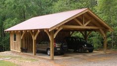 two cars are parked in a carport with a metal roof on the side of it