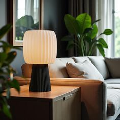 a lamp sitting on top of a table next to a couch