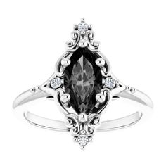 a white gold ring with an oval cut black diamond in the center and diamonds around it