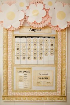 a wall calendar with paper flowers on it