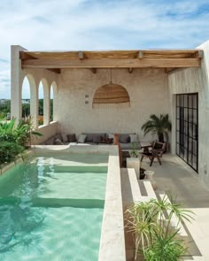 an outdoor patio with a pool and seating area