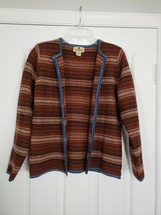 Vintage Woolrich Sweater Cardigan 100% Wool Button Ribbon Raisin Brown Large. Great condition! Lovely striped design with blue trim. Colors are like a rust/orange brown, dark brown and tan. *Pilling throughout, kind of itchy like most pure wool.* Approx. measurements (when buttoned)- Pit to pit: 19" Length from shoulder to bottom hem: 24" Sleeve length: 24" Will ship out within 1 business day of payment. Thanks! Vintage Long Sleeve Cardigan For Layering, Vintage Style Long Sleeve Cardigan For Layering, Vintage Brown Sweater For Layering, Vintage Brown Outerwear For Layering, Vintage Brown Cardigan With Button Closure, Vintage Brown Long Sleeve Cardigan, Brown Vintage Long Sleeve Cardigan, Funky Cardigans, Retro Sweaters