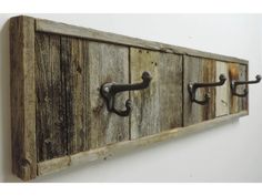 an old wooden coat rack with metal handles