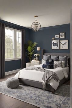 a bedroom with blue walls and white bedding