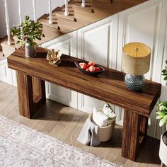 a wooden table with fruit on it next to stairs