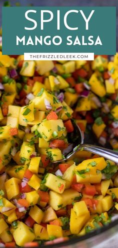 mango salsa in a glass bowl with a spoon on the side and text overlay that reads spicy mango salsa