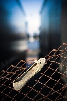 an old pair of shoes sitting on top of a net