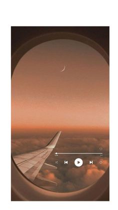 an airplane window with the view of clouds and a crescent in the sky above it