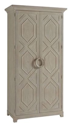 an armoire with two doors and a circular handle on the door, in grey wood