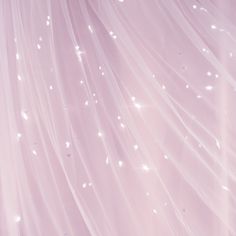 a pink background with white stars and sparkles